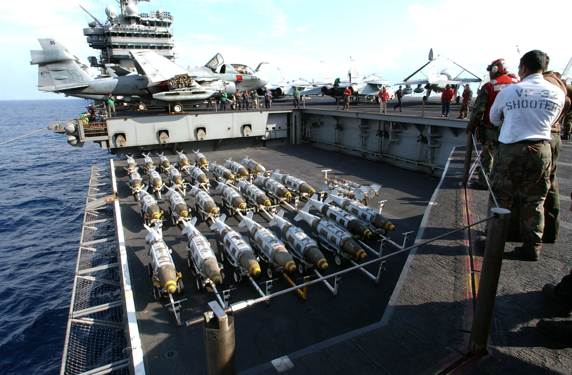 US Navy 030321 N 3235P 510 On The Flight Deck Aboard The Aircraft Carrier USS Harry S. Truman (CVN 75)%2C 2000 Lbs GBU 31 Joint Direct Attack Munitions (JDAM) Are Transported To The Flight Deck 