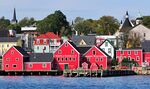 Red wooden houses at the shore