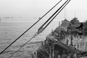 View looking forward from the bridge of the HQ-800 with many refugees and tents visible on deck.