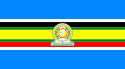 Nine horizontal strips coloured (from top to bottom): blue, white, black, green, yellow, green, red, white, then blue. The emblem of the EAC is placed in the centre.