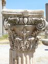 Composite capital whose design includes acanthus leaf, and volute motifs