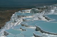 The water flows over the slopes into pools, the small basins surrounding them and finally into the fields below. It is in this way that these terraces over 100 m in height composed of layers of the accumulated limestone sediment have been gradually formed in the course of the