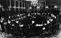 London Conference, St. James' Palace, February 1939. Palestinian delegates (foreground), Left to right: Fu'ad Saba, Yaqub Al-Ghussein, Musa Alami, Amin Tamimi, Jamal Al-Husseini, Awni Abdul Hadi, George Antonius, and Alfred Roch. Facing the Palestinians are the British, with Sir Neville Chamberlain presiding. To his right is Lord Halifax, and to his left, Malcolm MacDonald.