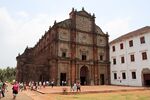 A church in red brick and an adjacent building in white