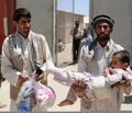 A man carrying a child with a bandaged leg leaves the Egyptian Field Hospital at Bagram Airfield, in Parwan province, Afghanistan, May 29, 2011 110529-A-IB797-057.jpg