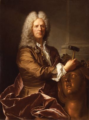 پورتريه للنحات Nicolas Coustou in full grey wig, his expression with a slight smile, and holding a hammer, with which he is working on the head of a large bronze female figure