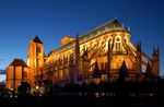 A moderately lit "T"-shaped cathedral shines at dusk.