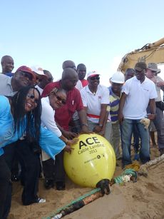 Celebrants touch lead buoy during cable landing.