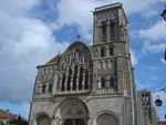 A grey stone church with a tower on the right side of the building.