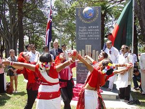 Outdoor ceremony, with girls in red-and-white costumes dancing