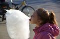 Girl eating cotton candy, Bangladesh