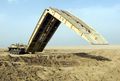 An M60A1 Armored Vehicle Launched Bridge (AVLB), deploying its scissors-type bridge.