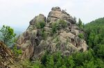 A large rock formation in a forest