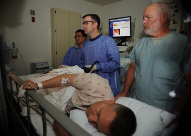 US Navy 110405-N-KA543-028 Hospitalman Urian D. Thompson, left, Lt. Cmdr. Eric A. Lavery and Registered Nurse Steven Cherry review the monitor whil.jpg