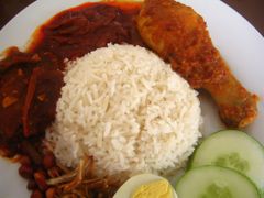 Nasi lemak with spicy chicken, sambal belacan, anchovies and peanuts, egg and cucumber, served in Malaysia
