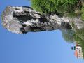 The Cudgel of Hercules, a tall limestone rock and Pieskowa Skała Castle in the background.