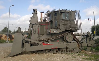 IDF D9T (4th generation armor) parking near a military outpost (left-side view)