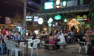 سياح يجلسون خارج بار في Chiang Mai، تايلاند.