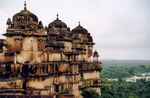 A palace overlooking a forest and a river