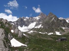 Mountain with glacier and mountain hut below