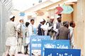 Afghans wait in line outside of the Egyptian Field Hospital at Bagram Airfield.jpg