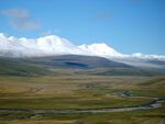 Plains and snow covered mountains