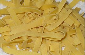 Wide, uncooked egg noodles