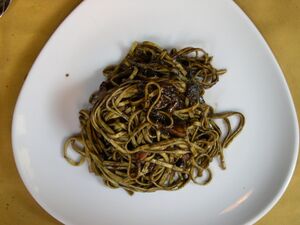 Three-sided white plate containing linguini