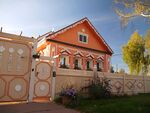 A decorated wooden house and a fence in front