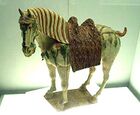 A Chinese Tang dynasty tri-color glazed porcelain horse (ح. 700 AD), using yellow, green and white colors.