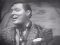 Bill Haley of Bill Haley and the Comets singing Rock Around the Clock, 1955