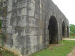 A gate built of massive grey stones.