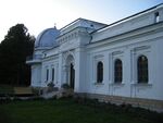 An astronomical observatory tower and surrounding buildings