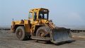 A wheeled bulldozer in an open pit coal mine