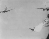 A B-17 bomber bursts into flames after being hit by flak over Ploiești