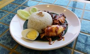 Nasi lemak with chili squid, anchovy and peanuts, egg and cucumber, served in Indonesia
