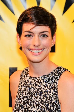 A broadly smiling young woman, looking toward the camera.