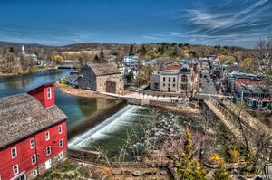 A view of Clinton, New Jersey with Red Mill in the foreground and the downtown district across the Raritan River in the background