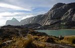 A rocky hill beside a lake.