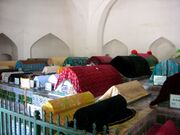 Tombs are decorated with blue glazed tiles and draped in colorful silks.