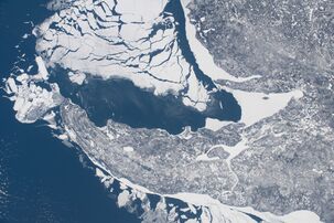 Some shelf ice remains along the shore of the peninsula as most of the ice breaks away; taken at 11:12:06 AM Central Standard Time on February 20, 2021 from the International Space Station[10]