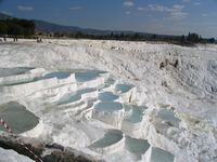 The temperature of the water forming the travertines, which issues from the hot springs on the hills above, falls to around 33°C lower down.